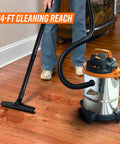 Person using Powerful 900W 3 Peak HP Stainless Steel Wet Dry Vacuum With 4 Gallon Tank, 360 Degree Wheels on hardwood floor.