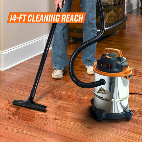 Person using Powerful 900W 3 Peak HP Stainless Steel Wet Dry Vacuum With 4 Gallon Tank, 360 Degree Wheels on hardwood floor.