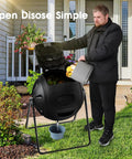 Person using Heavy Duty 35 Gallon Tumbling Compost Bin With Easy Drain Plug For Liquid Collection Rotating Outdoor Garden Waste Container Built To Last UV Protected Blue in a garden