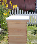 Telescoping Beehive Cover For 10 Frame Honeybee Hives Fully Assembled Amish Made In USA with metal top in garden setting