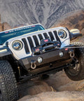 Warn Vro Evo 10 Standard Duty 12V DC Electric Winch With Steel Rope on a Jeep overcoming rocky terrain.