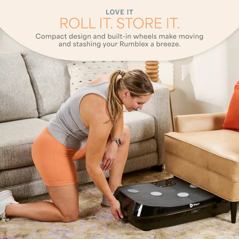 Woman storing Rumblex 4D Vibration Plate Exercise Machine with triple motor under a couch.