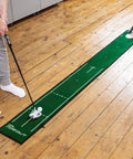 Person practicing on Slim Home Putting Mat For Fast Smooth Roll And Lower Scores, 7.9ft by 0.82ft green, rubber backed nylon surface