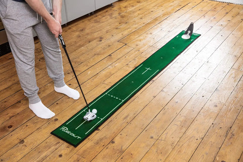 Person practicing on Slim Home Putting Mat For Fast Smooth Roll And Lower Scores, 7.9ft by 0.82ft green, rubber backed nylon surface