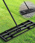 Two In One Lawn Leveling Rake With Dual Sided Design 32 By 10 Ground Plate And 78 Inch Adjustable Handle in use on grass and gravel