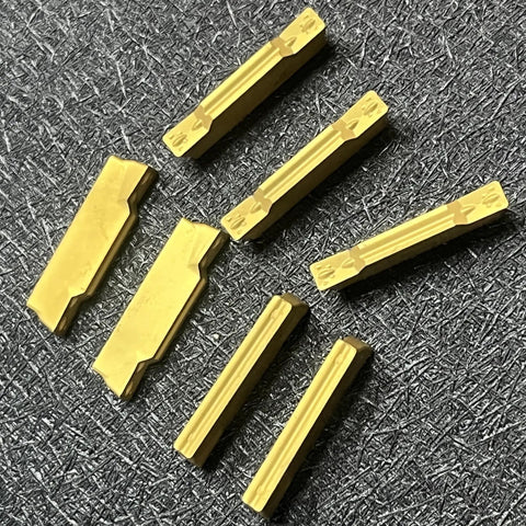 MGMN300-M Coated Carbide Inserts For CNC Lathe Grooving And Steel Cutting 3.00 Mm Thick 0.118 In 0.4 Mm Radius displayed on a surface
