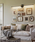 Black And Gold Rechargeable Wall Sconce Set Of Two Packing An Epic 8000 Mah Battery Delivering Up To Sixty Hours Of warm lighting above a cozy sofa.