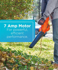 Person using a Powerful Corded Electric Leaf Blower For Quick Yard Cleanup on leaves, showcasing the 7 Amp motor power