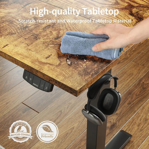 Person cleaning the rustic brown tabletop of Agilestic Height Adjustable Electric Standing Desk, 55x24 Inch, waterproof and scratch-resistant.