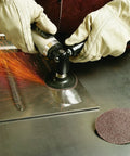 Worker using Roloc Disc 361F Cloth With TR Attachment Aluminum Oxide 3 Inch Diameter 60 Grit for sanding metal surface.