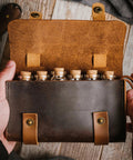 Open Leather Spice Wallet And Camping Spice Kit For Travel Seasoning Rack With Six Corked Vials on wood surface