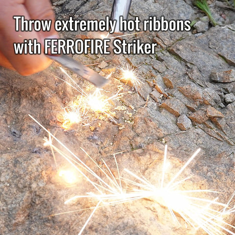 Two Pack Super Sharp Serrated Carbon Steel Ferro Rod Scraper igniting sparks on rocky surface for fire starting