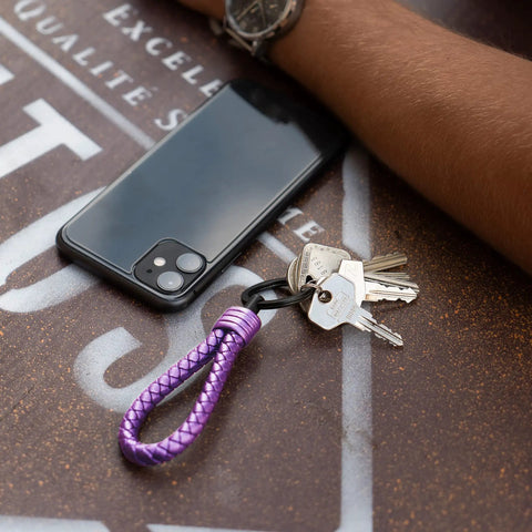 Premium Leather Keychain With Stainless Steel Ring And Extra Key Rings for cars, motorcycles, bicycles on table with phone