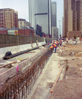 Construction site showing rebar installation for concrete, using Heavy Duty Epoxy Anchoring Formula For Threaded Rods And Rebar With Rapid Cure Setup In An Easy Squeeze 8.5 Oz Cartridge Pairing With A Smart Mix Tip For Rock Solid Installations That Really Deliver.
