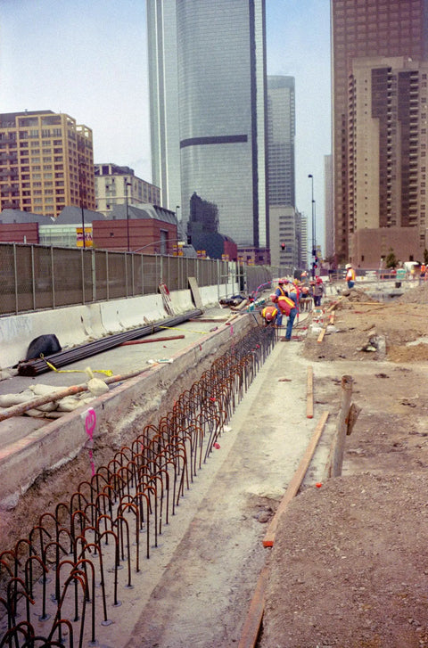 Construction site showing rebar installation for concrete, using Heavy Duty Epoxy Anchoring Formula For Threaded Rods And Rebar With Rapid Cure Setup In An Easy Squeeze 8.5 Oz Cartridge Pairing With A Smart Mix Tip For Rock Solid Installations That Really Deliver.
