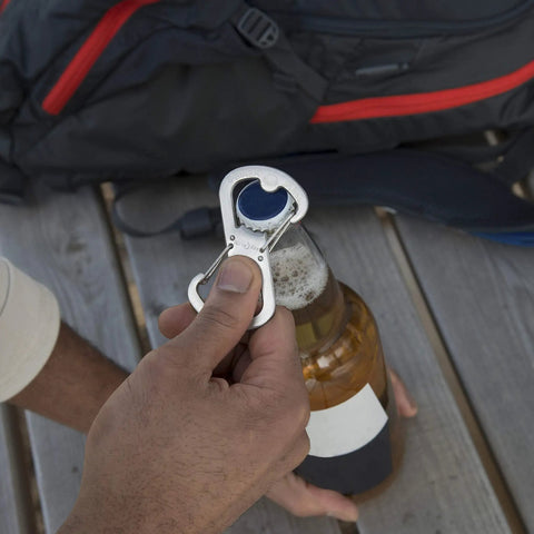 Using Dual Bottle Opener And SBiner Carabiner Combo In Stainless Steel on a beer bottle outdoors
