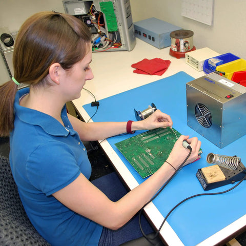 Person soldering with Portable Solder Smoke Fume Extractor For Soldering, Jewelry Making, And Crafting on a blue workbench