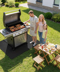 Family grilling on patio with Under Grill Mat For Outdoor Grills Large 60 By 40 Inches Double Sided Fireproof Pad visible under grill.