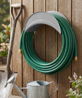 Heavy Duty Wall Mount Hose Hanger 2 Pack Sturdy Iron Metal Rack holding green garden hose on wooden wall with tools.