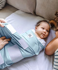 Newborn in sky blue Adjustable Baby Swaddle For Newborns That Feels Like The Womb Pediatrician Recommended Safe Sleep Solution.