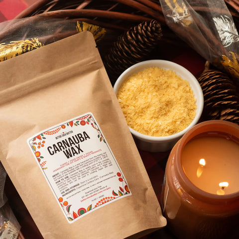 Straight Up Pure Carnauba Wax Flakes For Smooth Skin Care And Lip Balm Making Real Deal Vegan Candle Wax With Leather And Wood Finish Must Have DIY Staples Eight Ounce Bag with yellow wax flakes and candle.