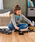 Child playing with John Deere 1:16 Scale Farm Construction Set with Skid Steer And Chevy Silverado Lights, Sounds And Barricades