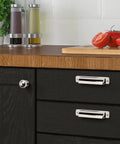 Top Shelf 1 Inch Vintage Ball Cabinet Knobs Polished Nickel Drawer Pulls on black kitchen drawers with tomatoes and condiments.