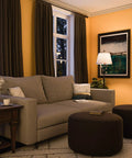 Cozy living room with Rustic Oil Rubbed Bronze Floor Lamp With Leaf Finial And Gold Tapered Shade, illuminating a couch and decor.