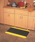 Diamond Plate Select UltraSoft Anti Fatigue Floor Mat 4 Ft By 2 Ft 15 16th Inch Thick Black With Yellow Edge in workshop.
