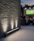 36W LED Wall Washer Light Bars, 2ft 5000K Daylight Outdoor Wall Washer Lights, illuminating a patio with people watching TV outdoors.