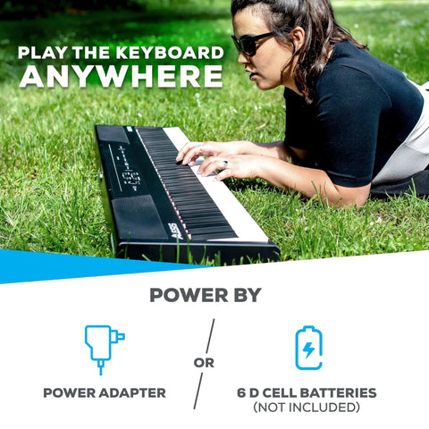 Person playing Beast 88 Key Semi Weighted Digital Piano Keyboard With Built In Forty Watt Stereo Speakers outdoors on grass.