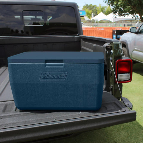 48 Quart Portable Cooler With Ice Retention Up To 60 Hours And TempLock Foam on a truck bed, sapphire color.