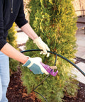 Person using Effortless Drip Irrigation Tubing Cutter For One Quarter To Three Quarter Inch Tubing With Clean Cuts No Jagged Edges Razor Sharp Stainless Steel Blade Ergonomic Handle And Recessed Wells For Less Force And Faster Installations in garden