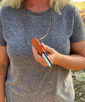 Person holding Compact European Fire Steel Ferro Rod With Magnesium On A Durable Lanyard Trail Ready Go To Emergency Fire Starter.