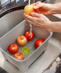 Heavy Duty Plastic Sink Wash Basin For Dishes, Large Multipurpose Dishpan With Drain Plug, gray basin with apples being washed