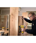 Man wearing Reinforcer Rx Bifocal High Performance Protective Eyewear With Rubber Temples And Protective Eyeglass Sleeve Clear Lens 1.5 Diopter using a nail gun in a workshop.