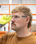 Kickass Rimless Wraparound Safety Glasses With Ultra Light Twenty One Gram Flex Plus Heavy Duty Dust Defense And Never Fog Tech, worn by a worker.