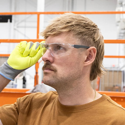 Kickass Rimless Wraparound Safety Glasses With Ultra Light Twenty One Gram Flex Plus Heavy Duty Dust Defense And Never Fog Tech, worn by a worker.
