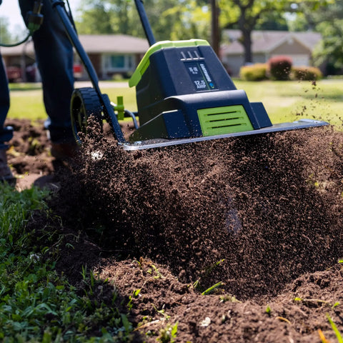Corded Electric Garden Tiller Cultivator With 12.5 Amp Motor 16 Inch Tilling Width slicing through soil in a garden setting