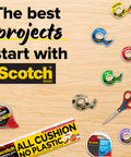 The best projects start with Scotch brand tape, multiple tape dispensers in various colors, scissors, and packaging boxes on wood.
