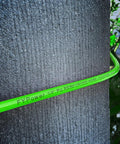 Built Like A Tank 1/4 Inch By 50 Feet Reinforced Polyurethane Air Compressor Hose coiled on textured surface.