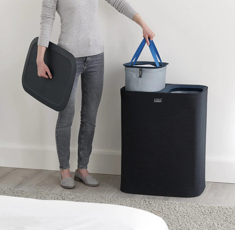 Person using Tota 90 Liter Laundry Hamper With Dual Compartment Separation And Lid Includes 2 Removable Wash Bags With Handles For Easy Sorting