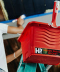 Pro Go Paint And Tool Bucket With Brush Holder Attaches To Most Ladders One Gallon Capacity Red Ladder Caddy in use on ladder