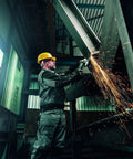 Worker using Heavy Duty 6-Inch Angle Grinder With Brake, Anti-Vibration, 14.5 Amp, in industrial setting with sparks