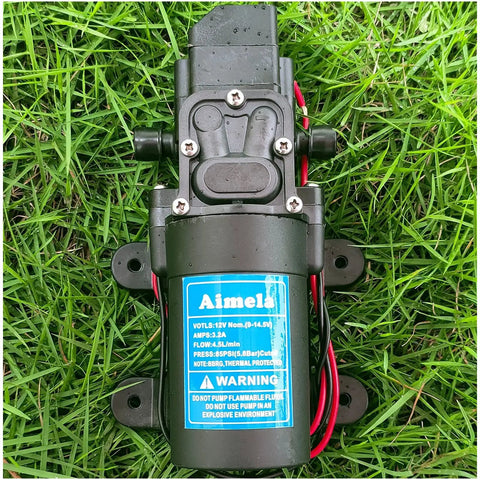 12V DC Fresh Water Pump With 2 Hose Clamps For Marine And Lawn Use Self Priming Sprayer Pump 85 PSI Durable PPS Construction on grass