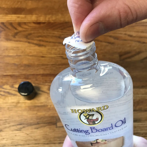 Opening 12 oz bottle of Food Grade Mineral Oil For Wood Cutting Boards And Butcher Blocks, Odorless Tasteless Colorless