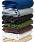 Stack of folded tarps in various colors, including the Waterproof Heavy Duty Silicone Coated Polyester Tarp Built Tough As Nails with Rustproof Grommets for Awnings Camping Construction Gear Covers and Outdoor Use 10 by 10 Feet Black.