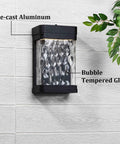 Lit LED Porch Light Dusk To Dawn Wall Sconce With Bubble Glass, die-cast aluminum frame on exterior wall, close-up view