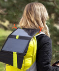 Woman hiking with solar backpack secured by Gear Tie Original ProPacks Reusable Rubber Twist Ties For Indoor And Outdoor Use.
