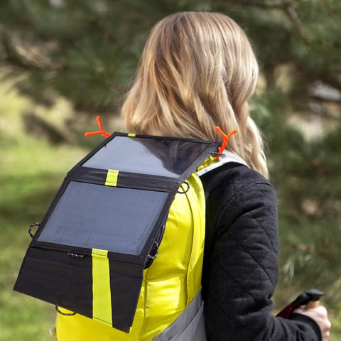 Woman hiking with solar backpack secured by Gear Tie Original ProPacks Reusable Rubber Twist Ties For Indoor And Outdoor Use.